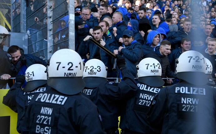 Schalke's supporters face police officers after the German First division Bundesliga football match BVB Borussia Dortmund v Schalke 04 in Dortmund, western Germany on April 27, 2019. (Photo by INA FAS