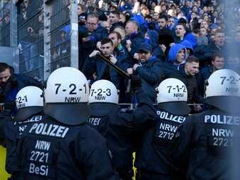 Schalke's supporters face police officers after the German First division Bundesliga football match BVB Borussia Dortmund v Schalke 04 in Dortmund, western Germany on April 27, 2019. (Photo by INA FAS Schalke's supporters face police officers after the German First division Bundesliga football match BVB Borussia Dortmund v Schalke 04 in Dortmund, western Germany on April 27, 2019. (Photo by INA FAS