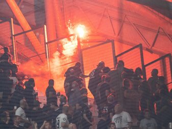 Ein Feuerwerkskörper wird in Marseille von Ultras aus ihrem Block geworfen. Ein Feuerwerkskörper wird in Marseille von Ultras aus ihrem Block geworfen.