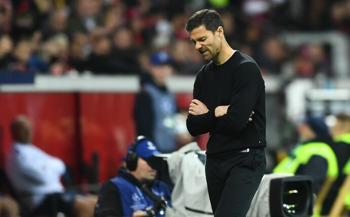 Leverkusens Trainer Xabi Alonso steht mit verschränkten Armen an der Seitenline.