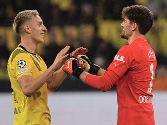 Dortmunds Torwart Gregor Kobel (r) klatscht mit Nico Schlotterbeck nach gehaltenem Elfmeter ab. Dortmunds Torwart Gregor Kobel (r) klatscht mit Nico Schlotterbeck nach gehaltenem Elfmeter ab.