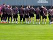 Die Spieler vom FC Bayern München stehen beim Training zusammen.