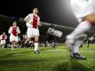 Spieler von Ajax Amsterdam laufen bei einem Freundschaftsspiel auf Kunstrasen auf. Foto: anp Vincent Jannink
