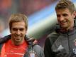 Philipp Lahm (l) glaubt an Thomas Müllers Torjägerqualitäten. Foto: Andreas Gebert