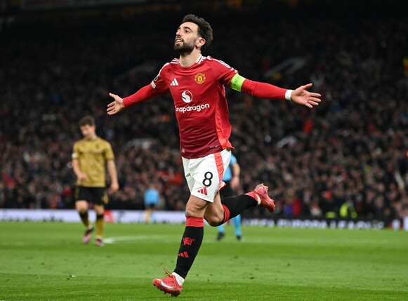 MANCHESTER, ENGLAND - MARCH 13: Bruno Fernandes of Manchester United celebrates scoring his team's third goal and competing his hat-trick during the UEFA Europa League 2024/25 Round of 16 Second Leg m
