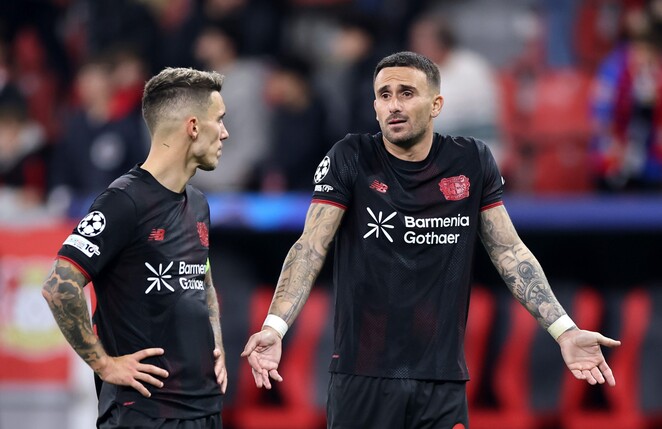 LEVERKUSEN, GERMANY - OCTOBER 01: Alex Grimaldo (L) of Bayer Leverkusen speaks with teammate Aleix Garcia after the UEFA Champions League 2025/26 League Phase MD2 match between Bayer 04 Leverkusen and