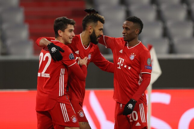 MUNICH, GERMANY - DECEMBER 09: Eric Maxim Choupo-Moting of FC Bayern Munich celebrates with team mates Marc Roca and Bouna Sarr (R) after scoring their sides second goal during the UEFA Champions Leag