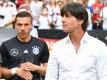 Lukas Podolski (l) wird ein letztes Mal unter Joachim Löw spielen. Foto: Arne Dedert