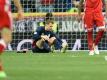 Torwart Manuel Neuer sitzt auf dem Rasen und hält sich den verletzten linken Fuß. Foto: Andreas Gebert