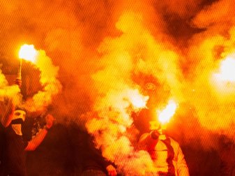 Vermummte Ultras hantieren mit Pyrotechnik. Foto: Bernd Thissen Vermummte Ultras hantieren mit Pyrotechnik. Foto: Bernd Thissen