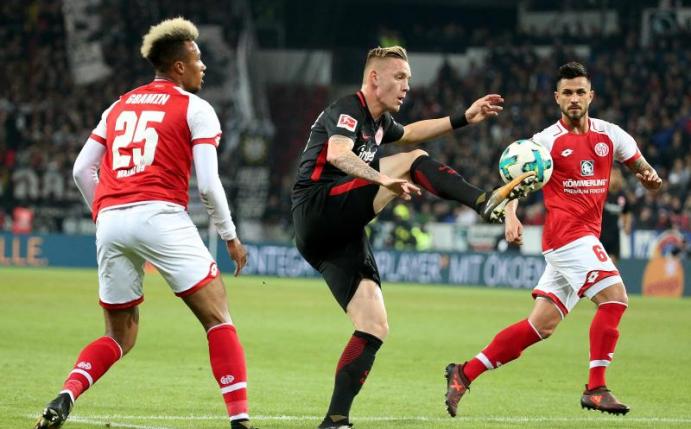 Marius Wolf von Eintracht Frankfurt kämpft mit den Mainzern Jean-Philippe Gbamin (l) und Danny Latza (r) um den Ball. Foto: Hasan Bratic