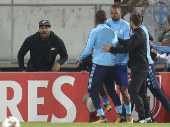 Patrice Evra von Olympique Marseille wird von seinem Teamkollegen Rolando von einem Zuschauer weggezogen. Foto: Luis Vieira Patrice Evra von Olympique Marseille wird von seinem Teamkollegen Rolando von einem Zuschauer weggezogen. Foto: Luis Vieira