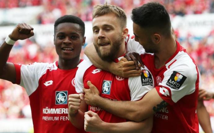Die Mainzer Alexandru Maxim (M), Ridle Baku (l) und Gerrit Holtmann jubeln über das 2:0. Foto: Thomas Frey