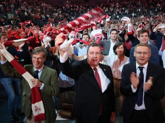 Die designierten Vorstände Werner Wolf (M), Jürgen Sieger (l.) und Eckhard Sauren (r) singen die FC-Hymne. Foto: Henning Kaiser