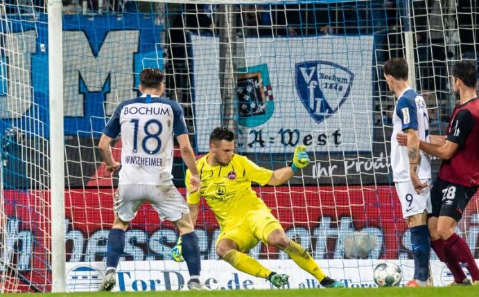 Bochums Manuel Wintzheimer (l) hat das Tor zum 3:0 gegen Nürnbergs Torwart Patric Klandt (M) erzielt. Foto: Marcel Kusch/dpa