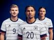 Timo Werner (l), Serge Gnabry (M) und Nico Schulz im neuen DFB-Trikot. Foto: -/adidas/dpa