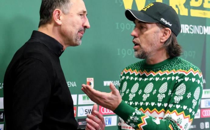 Mainz-Trainer Achim Beierlorzer (l) spricht mit FCA-Coach Martin Schmidt: Am Pullover lag es nicht. Foto: Stefan Puchner/dpa