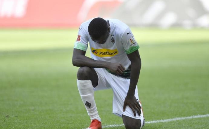 Mönchengladbachs Marcus Thuram kniet nach seinem ersten Treffer der Partie auf dem Rasen. Foto: Martin Meissner/AP Pool/dpa