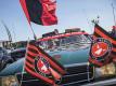 Fußballfans verfolgen das Spiel zwischen dem FC Midtjylland und dem AC Horsens auf dem Parkplatz vor dem Stadion. Foto: Mikkel Berg Pedersen/Ritzau Scanpix/AP/dpa