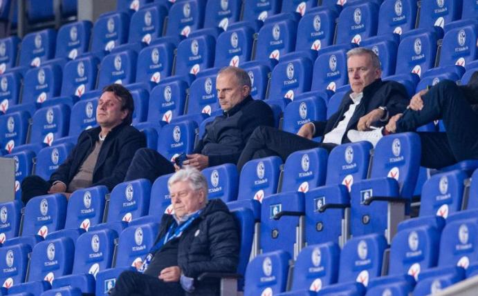 Die Schalker Führungsetage um Jochen Schneider (2.v.l.) verfolgt die Partie gegen Bremen. Foto: Guido Kirchner/dpa