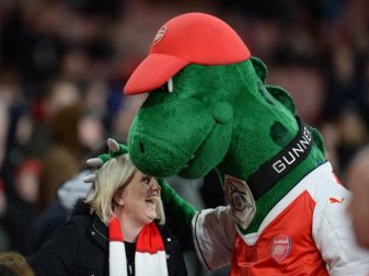 Bei den Fans beliebt Arsenal-Maskottchen «Gunnersaurus» umarmt vor Spielbeginn eine Frau. Foto: picture alliance / Andreas Gebert/dpa Bei den Fans beliebt Arsenal-Maskottchen «Gunnersaurus» umarmt vor Spielbeginn eine Frau. Foto: picture alliance / Andreas Gebert/dpa