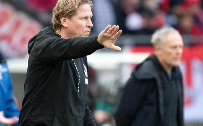 Hat eine hohe Meinung von Freiburg-Trainer Christian Streich (hinten): Kölns Markus Gisdol. Foto: Federico Gambarini/dpa