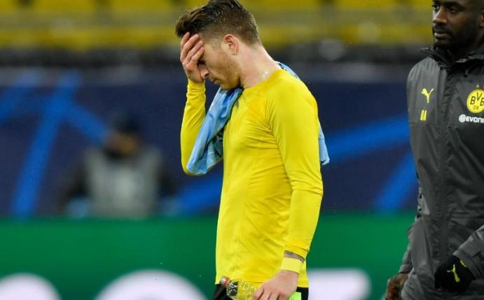 Dortmunds Kapitän Marco Reus (l) verlässt traurig den Platz. Der Tram vom Halbfinale ist geplatzt. Foto: Martin Meissner/AP-Pool/dpa