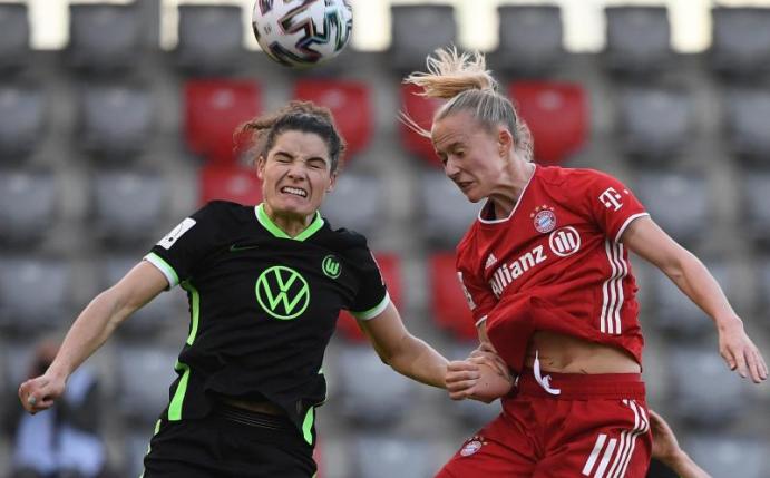 Lea Schüller (r) vom FC Bayern München im Kopfballduell mit der Wolfsburgerin Dominique Janssen. Foto: Angelika Warmuth/dpa