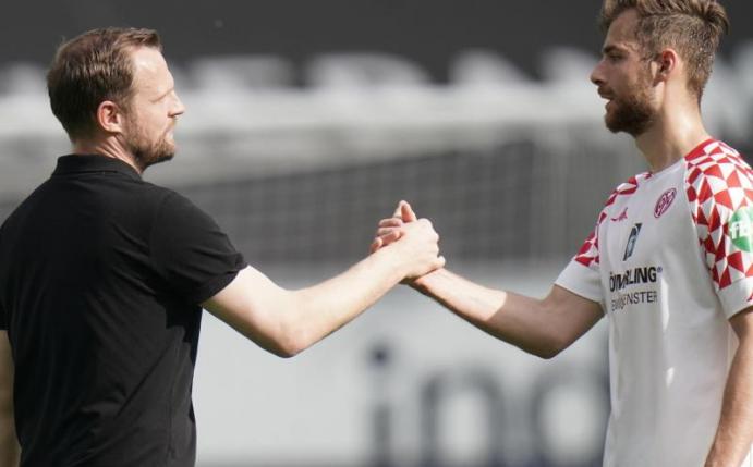 Mainz-Trainer Bo Svensson (l) klatscht nach dem Spiel mit Abwehrspieler Alexander Hack ab. Foto: Thomas Frey/dpa
