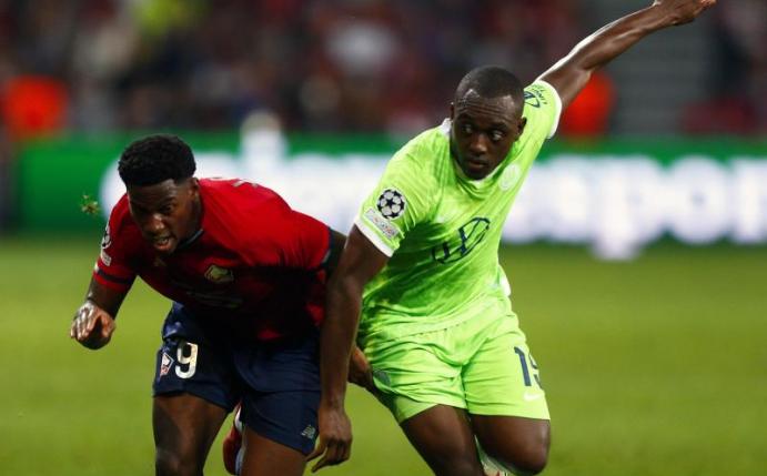 Jonathan David (l) vom OSC Lille gegen Kevin Mbabu vom VfL Wolfsburg. Foto: Michel Spingler/AP/dpa