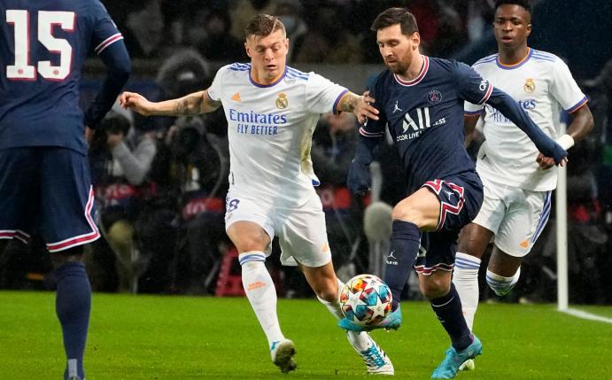 Lionel Messi (2.v.r) von PSG wird von Real Madrids Toni Kroos bedrängt.