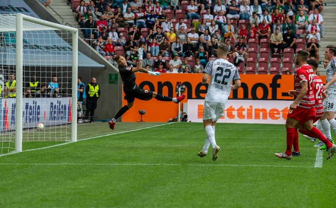 Augsburgs Torwart Rafal Gikiewicz (l) kann dem Ball beim 0:2 nur noch hinterherschauen.